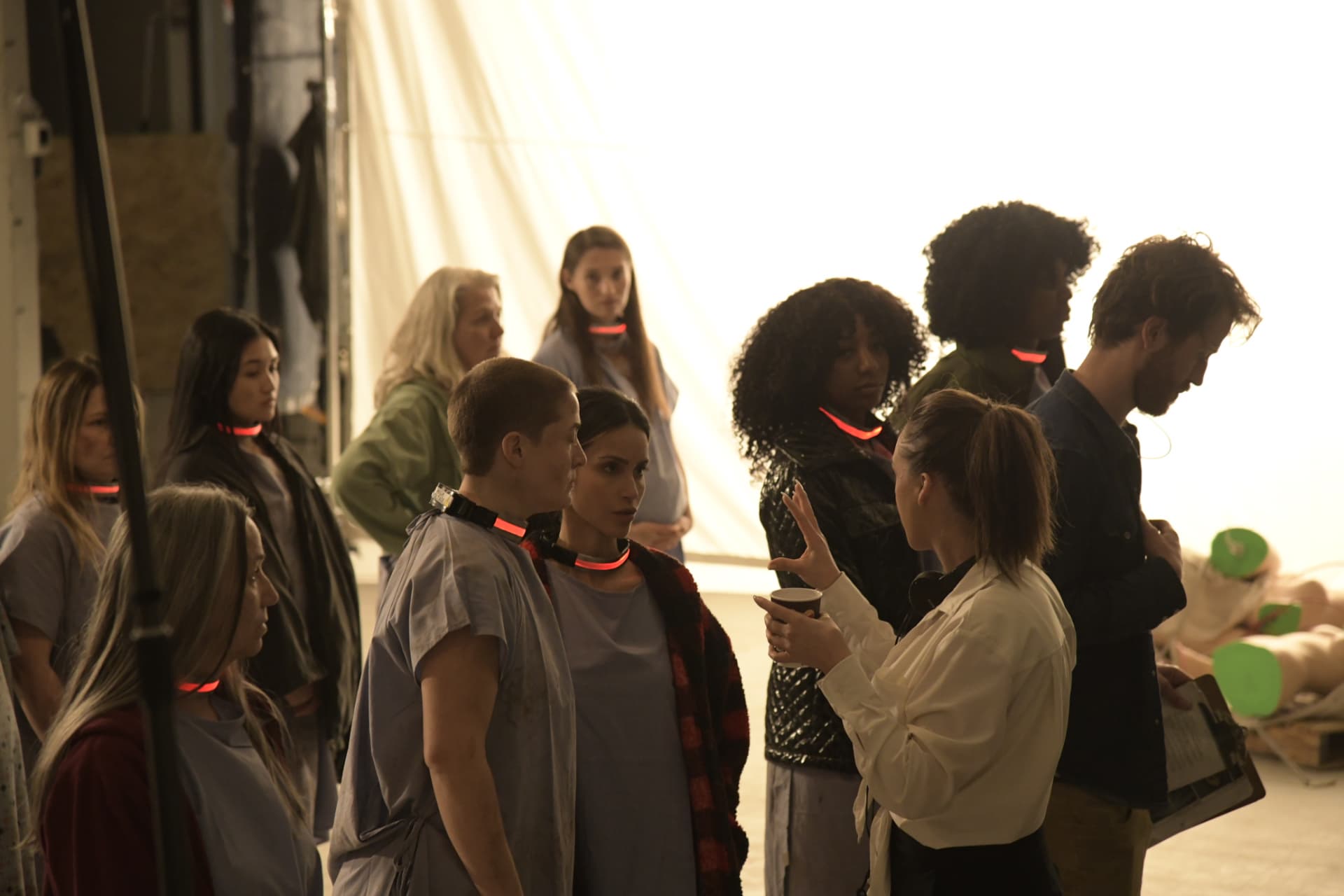 Directing the ensemble on the collar-lit soundstage.