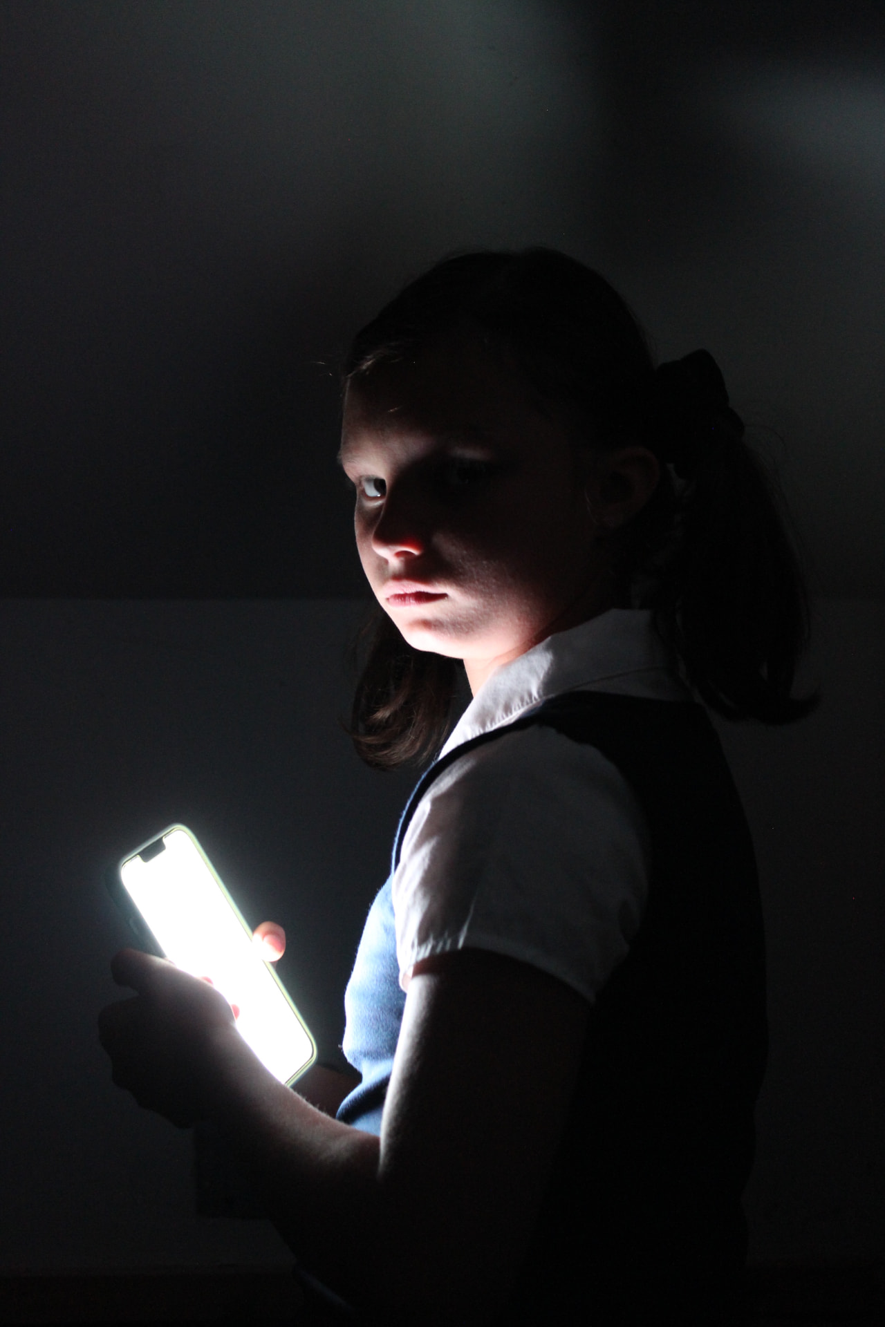 Screen-lit in the dark — Portrait of Consumption.